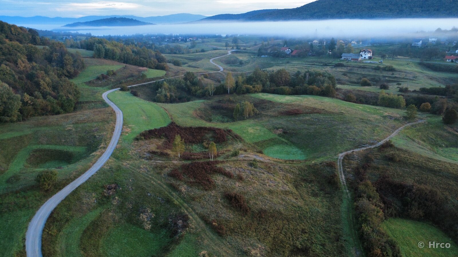 Winding road through misty hills